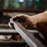 Close up of unrecognizable worker working with iron.