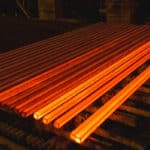 Hot square steel bloom on the roll table.