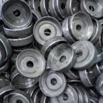 abstract heavy industry production full frame background stamped round workpieces